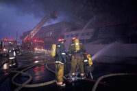 image shows firefighters responding to a large fire