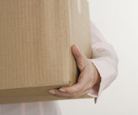 Photo shows a close view of someone carrying a box