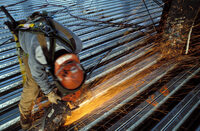 Photo shows a worker wearing protective clothing