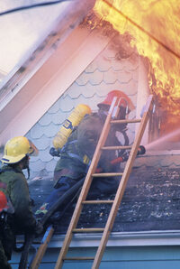 Photo shows firefighters tackling a house fire