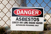 Photo shows an asbestos warning sign