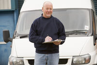 picture shows a man with a check list in front of a commercial van
