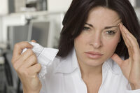 Photo shows a woman feeling ill in an office