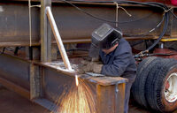Photo shows a worker welding and not using visor
