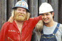 Photo shows two workers wearing head protection