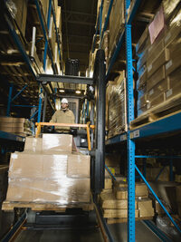 Photo shows a reach truck in a warehouse