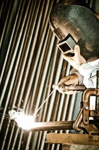photo shows a person welding